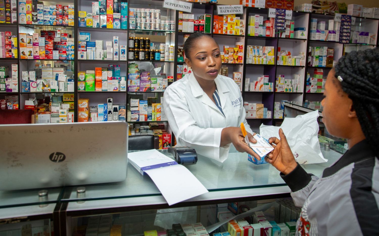 A Rofchem pharmacist helping a customer